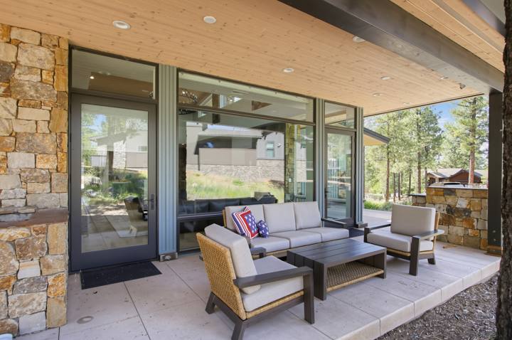 Covered patio with outdoor sofa and lounge chairs