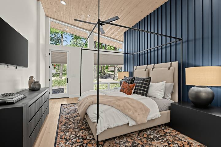 Second king suite with navy accent wall and canopy bed