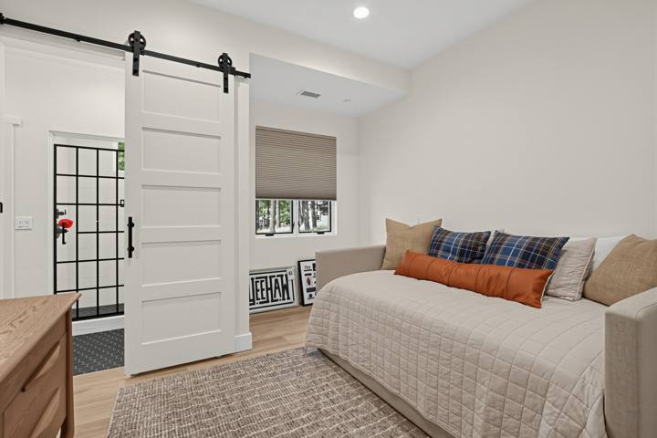 Bedroom with full daybed, trundle and sliding barn door