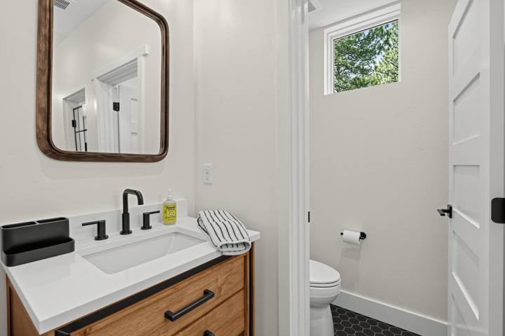 Bathroom vanity with round wood mirror