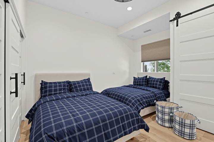 Bedroom with two full beds and plaid bedding
