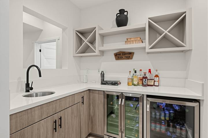 Wet bar with sink, wine storage and two beverage fridges