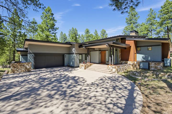 Front elevation with two-car garage and entry walk in Pine Canyon